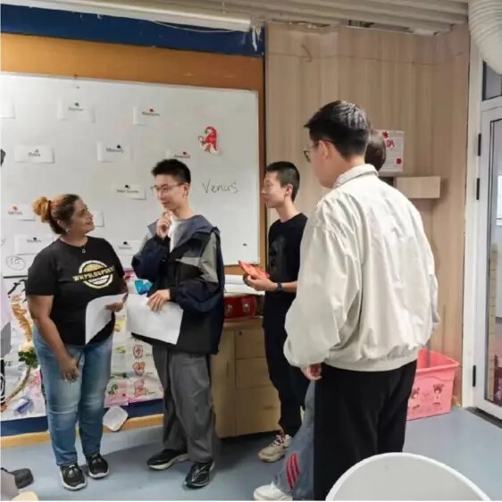 Charmaine speaking and interacting with high-school students during an English lesson